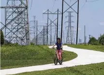  ?? Steve Gonzales / Staff file photo ?? A cyclist uses a recreation­al trail along CenterPoin­t Energy’s easement near Hiram Clarke in southwest Houston.