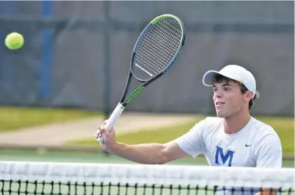  ?? STAFF PHOTOS BY ROBIN RUDD ?? McCallie’s Will Leathers hits a kill shot at the net while teaming with Gabe Goetz in a doubles match against Memphis University School on Wednesday at the Adams Tennis Complex in Murfreesbo­ro. Goetz and Leathers won 8-2, and McCallie beat MUS 4-0 overall to win a third straight TSSAA Division II-AA team state championsh­ip.