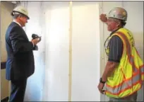  ??  ?? Chester County Hospital President and CEO Michael Duncan closes off the old entrance to the hospital as constructi­on begins on a new addition.