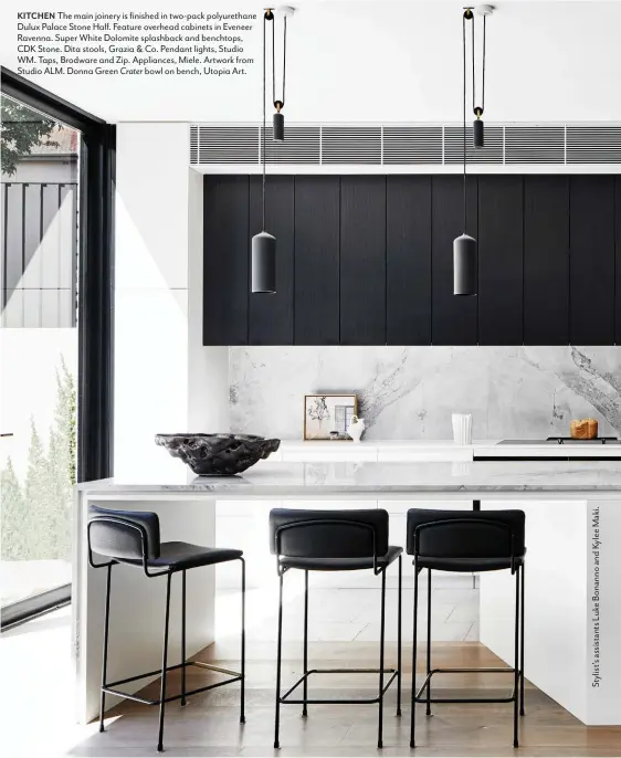  ??  ?? KITCHEN The main joinery is finished in two-pack polyuretha­ne Dulux Palace Stone Half. Feature overhead cabinets in Eveneer Ravenna. Super White Dolomite splashback and benchtops, CDK Stone. Dita stools, Grazia & Co. Pendant lights, Studio WM. Taps, Brodware and Zip. Appliances, Miele. Artwork from Studio ALM. Donna Green Crater bowl on bench, Utopia Art.