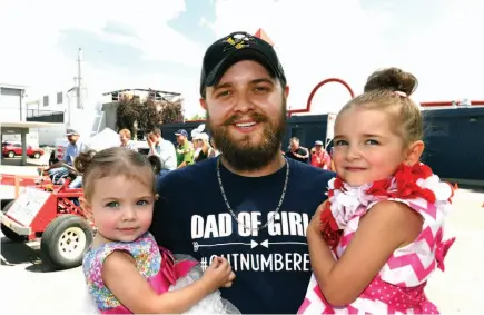  ?? CITIZEN PHOTO BY BRENT BRAATEN ?? Andrew Rice holds daughters Tatum, 14 months, left, and three-and-a-half-year-old Marley. Andrew had open heart surgery at six months old and again at age eight. He’s now 27.