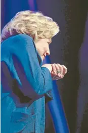  ?? Photo: REUTERS ?? Quick move: Former US secretary of state Hillary Clinton ducks as a shoe is thrown on stage by a woman during Clinton’s speech to members of the Institute of Scrap Recycling Industries in Las Vegas, Nevada. ‘‘My goodness, I didn’t know that solid waste...