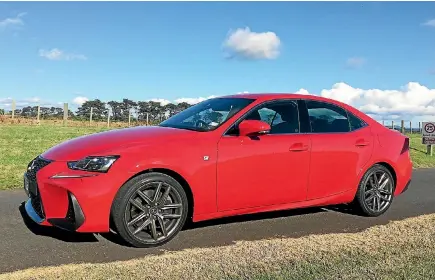  ?? ROB MAETZIG ?? The Lexus IS200T F-sport, resplenden­t in its hot red paintwork.