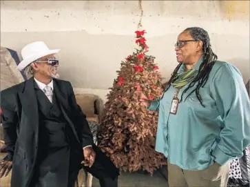  ?? Irfan Khan Los Angeles Times ?? ROWE CHATS with Ceola Waddell Jr., a.k.a. Mr. Dice, at his encampment on 39th Street. Rowe, who will leave the L.A. Homeless Services Authority, plans to do outreach in retirement. “I’ll be a rogue agent,” she says.