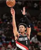  ?? Amanda Loman / Associated Press ?? Portland guard Anfernee Simons takes a 3-point shot during the first half against New York. He was 6-for-12 from 3-point range.