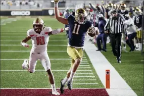  ?? MICHAEL DWYER — THE ASSOCIATED PRESS ?? Notre Dame wide receiver Ben Skowronek (11) runs the ball in for a touchdown against Boston College defensive back Brandon Sebastian (10) during the first half of an NCAA college football game, Saturday, Nov. 14, 2020, in Chestnut Hill, Mass.