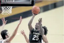  ?? Amanda Loman, The Associated Press ?? Colorado’s McKinley Wright IV shoots over Oregon State’s Roman Silva, left, during the second half Saturday in Corvallis, Ore.