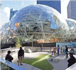  ?? ELAINE THOMPSON/ASSOCIATED PRESS ?? Large spheres and a dog park are part of the architectu­re and features at an Amazon facility in Seattle.