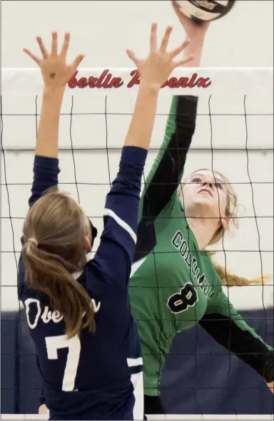  ?? JENNIFER FORBUS — FOR THE MORNING JOURNAL ?? Columbia’s Lorelei Sikorski shoves the volleyball over the net as Oberlin’s Kyria Lopez reaches up to block.