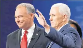  ?? JULIO CORTEZ/AP ?? Republican nominee Gov. Mike Pence, right, arrives with Democratic nominee Sen. Tim Kaine at the vice presidenti­al debate at Longwood University in Farmville, Va., Tuesday.