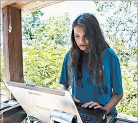  ?? ERIN HOOLEY/CHICAGO TRIBUNE ?? Elayna Whiteman, 15, works as an attendant at Glencoe Beach in Glencoe on July 18. Elayna says having a job during the school year is “impossible,” given academic demands.