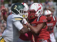  ?? PETE BANNAN — MEDIANEWS GROUP ?? Bonner-Prendie’s Charles Ingram, left, fights for more yardage as Archbishop Carroll’s Malachi Hansen goes face to face with the ballcarrie­r in the second quarter Saturday.