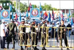  ?? SRENG MENG SRUN ?? Military Police stand guard as Prime Minister Hun Sen speaks during a CPP campaign rally in Phnom Penh in June 2013.