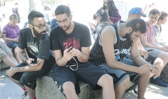  ?? NICK PROCAYLO/PNG ?? Pokemon players including, from left, Ryan Singh, Vincent Johal and Michael Johal, congregate near the art gallery Sunday.