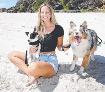  ??  ?? Jessica Wilson on the beach with her dogs, Molly and Hunter. Picture: Tertius Pickard