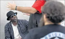  ?? Brian van der Brug Los Angeles Times ?? WILLIAM PRUITT, left, an Army veteran, talks with people counting the homeless on skid row. The mayor wanted to get all veterans off the streets this year.