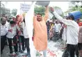  ??  ?? Protesting farmers and NCP activists throw away milk on the road outside Collector's office in Thane on Saturday.