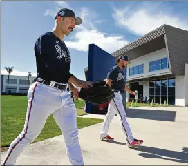  ?? HYOSUB SHIN/HYOSUB.SHIN@AJC.COM ?? Braves starter Spencer Strider (left) and reliever Kirby Yates head to the mound Thursday for spring training at Cooltoday Park in North Port, Florida.