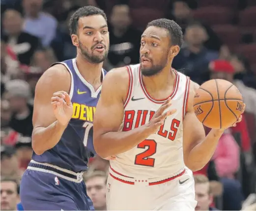  ?? NAM Y. HUH/AP ?? Jabari Parker, guarded by Nuggets forward Trey Lyles, had a game-high 19 points and shot 7-for-11 from the field, including 3-for-6 from three-point range.