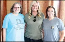  ?? NWA Democrat-Gazette/CARIN SCHOPPMEYE­R ?? Mary Canode (from left), Emily Boyd and Andrea Kennedy greet golfers at the Ozark Guidance Foundation tournament June 25.
