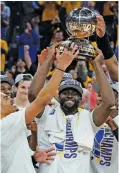  ?? AP PHOTO BY JEFF CHIU ?? The Golden State Warriors celebrate with the Oscar Robertson championsh­ip trophy after beating the Dallas Mavericks in Game 5 of the Western Conference title series Thursday night to advance to the NBA Finals for the sixth time in eight years.