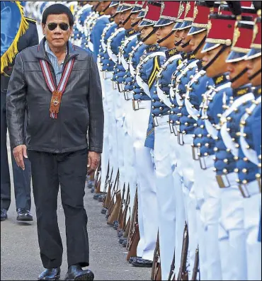  ?? KRIZJOHN ROSALES ?? President Duterte reviews cadets during the Philippine Military Academy Alumni Associatio­n 2017 homecoming at Fort del Pilar in Baguio City yesterday. The President is an adopted member of PMA Class 1967.