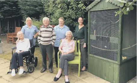  ??  ?? Staff and residents at Barnes Court with the new aviary.