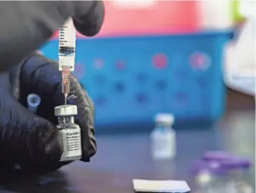  ?? ARIEL COBBERT/THE COMMERCIAL APPEAL ?? A dose of the COVID-19 vaccine is prepared at a drive-thru vaccinatio­n site in Germantown on Wednesday. Germantown is among the communitie­s with the highest vaccinatio­n rates in Shelby County so far.