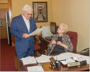  ?? MARK BUFFALO/THREE RIVERS EDITION ?? State Sen. Eddie Joe Williams, R-Cabot, reads over a Senate proclamati­on while speaking with Mary Jacks, administra­tive assistant and receptioni­st for the Arkansas State Senate in the state Capitol in Little Rock.