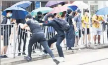  ?? CHINA DAILY ?? A group of radical protesters dismantle railings in Causeway Bay, Hong Kong to make road blocks on Sunday as an unlawful rally against a proposed national security law turned violent.