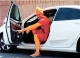  ?? BENJAMIN CHAMBERS/ARIZONA REPUBLIC ?? Basketball coach Patrick Battillo, AKA Phoenix Suns super fan “Mr. ORNG,” gets in his car in Phoenix on Wednesday.