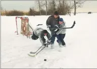  ?? Peter Hvizdak / Hearst CT Media file photo ?? Korie Yu, 13, Crew Reynolds, 14, and Mike Maddern, 14, take advantage of a snow day to play hockey on the artificial pond at Bradley Point in West Haven in January 2004.