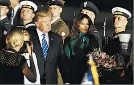  ?? CZAREK SOKOLOWSKI/AP ?? President Donald Trump and first lady Melania Trump arriveWedn­esday night inWarsaw, Poland, where the president is visiting on his way to a Group of 20 meeting in Germany.