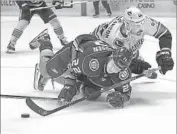  ?? Chris Carlson Associated Press ?? DUCKS CENTER Dennis Rasmussen, left, battles Canucks defenseman Erik Gudbranson for the puck.