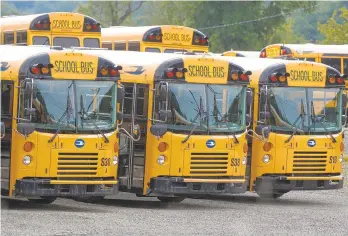  ?? KEITH SRAKOCIC/AP ?? Keeping kids and drivers safe from the coronaviru­s on school buses will be challengin­g. Mike Berk, of the Pennsylvan­ia School Bus Associatio­n, said districts are considerin­g how many students should be riding at once, how best and how often to clean buses, whether to have some drivers make repeated runs to limit ridership, and how to address mask wearing and health checks.