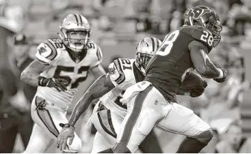  ?? Brett Coomer / Houston Chronicle ?? Texans running back Alfred Blue, right, breaks away from Panthers defenders for a 16-yard scoring run Wednesday. Blue has incorporat­ed yoga and Pilates into his training regimen to become quicker and stronger.