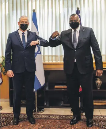  ?? US Secretary of Defence Lloyd Austin ?? US Secretary of Defence Lloyd Austin, right, meets Israel’s Defence Minister Benny Gantz and gives Israel an ‘iron-clad’ defence commitment