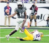  ?? STEPHEN M. DOWELL/ORLANDO SENTINEL ?? UCF defensive back Nevelle Clarke tries to pick off a pass intended for LSU receiver Justin Jefferson during the Jan. 1 Fiesta Bowl at State Farm Stadium in Phoenix, Ariz.