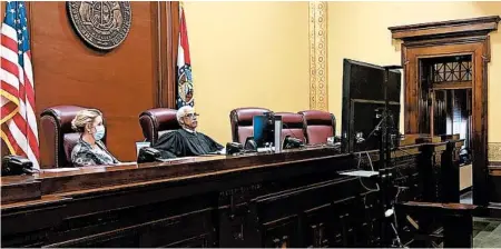  ?? BETH S. RIGGERT/SUPREME COURT OF MISSOURI ?? Supreme Court Clerk Betsy AuBuchon, left, and Chief Justice George Draper watch arguments from a monitor June 15 at the Missouri Supreme Court.