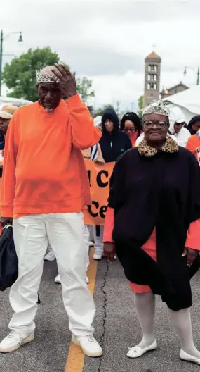  ?? BRAD VEST/THE COMMERCIAL APPEAL ?? Preston Hurt, left, and W. Estelle Taylor, right, march as king and queen of the Orange Mound Senior Center during the Africa in April Internatio­nal Diversity Parade on April 19, 2019. The 2021 Africa in April Cultural Awareness Festival will be Aug. 5-8.