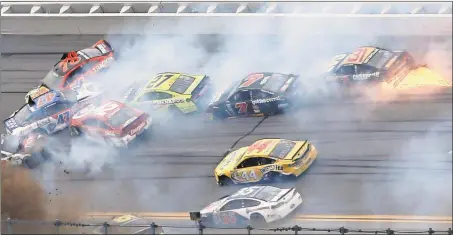  ?? John Bazemore / The Associated Press ?? Several cars collide in a crash during Sunday’s Sprint Cup race at Talladega Superspeed­way in Talladega, Ala. Brad Keselowski won the race.