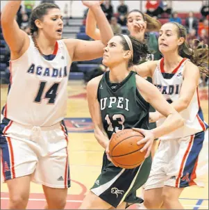  ?? PETER OLESKEVICH/SPECIAL TO THE GUARDIAN ?? UPEI Panthers forward Kiera Rigby, centre, drives to the paint against the Acadia Axewomen Saturday in Wolfville, N.S., during Atlantic University Sport basketball action.