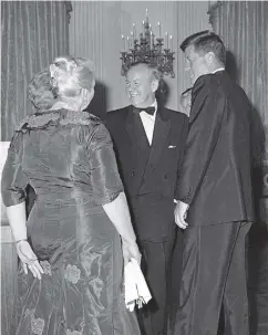  ?? BYRON ROLLINS / THE ASSOCIATED PRESS FILES ?? President John F. Kennedy and Lester Pearson, leader of Canada’s Liberal Party, talk before a Nobel Prize gala at the White House in the spring of 1962. Then-Canadian prime minister John Diefenbake­r was said to be enraged Pearson was invited instead of...
