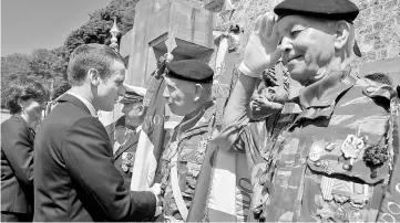  ??  ?? Macron (left) attends a ceremony marking the 77th anniversar­y of late French General Charles de Gaulle’s resistance call of June 18, 1940, at the Mont Valerien memorial in Suresnes, near Paris. — Reuters photo