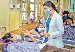  ?? - PTI ?? A doctor treats a patient infected with the black fungus at the NSCB Medical College and Hospital in Jabalpur on Saturday.