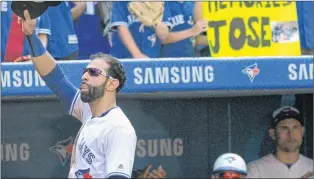  ?? CP PHOTO ?? Toronto Blue Jays’ Jose Bautista acknowledg­es the crowd after leaving the game against the New York Yankees during the ninth inning Sunday in Toronto.