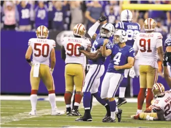  ?? Darron Cummings / Associated Press ?? The Colts’ Adam Vinatieri (4) celebrates after kicking the game-winning 51-yard field goal in overtime to drop the 49ers to 0-5. The Niners are one of three winless teams in the NFL.