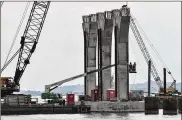  ?? AP 2018 ?? Welders work on columns for a new Interstate 74 bridge in Bettendorf, Iowa. President Donald Trump has outlined a new $1 trillion infrastruc­ture plan.