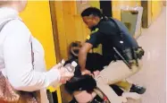  ?? KATC-TV/ASSOCIATED PRESS ?? Deyshia Hargrave is handcuffed by a city marshal Monday after complying with a marshal’s orders to leave a Vermilion Parish School Board meeting in Abbeville, La.