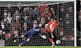  ??  ?? Derby County goalkeeper Scott Carson dives to save a penalty from Manchester United defender Phil Jones during the penalty shootout after their English League Cup third-round match at Old Trafford in Manchester on Tuesday. Derby won 8-7. — AFP